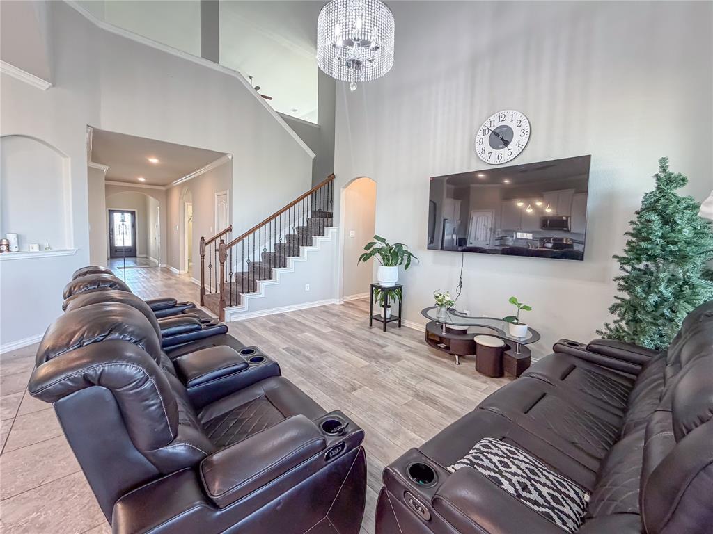 328 Callaghan Drive Fate, TX 75189 - Photo 19 of 37 a living room with furniture and a flat screen tv