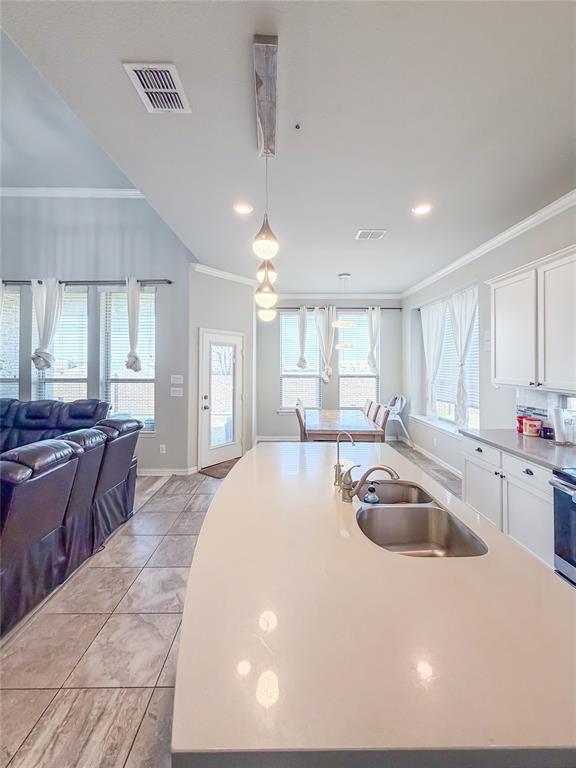 328 Callaghan Drive Fate, TX 75189 - Photo 37 of 37 a kitchen with kitchen island granite countertop a sink a counter top space and stainless steel appliances