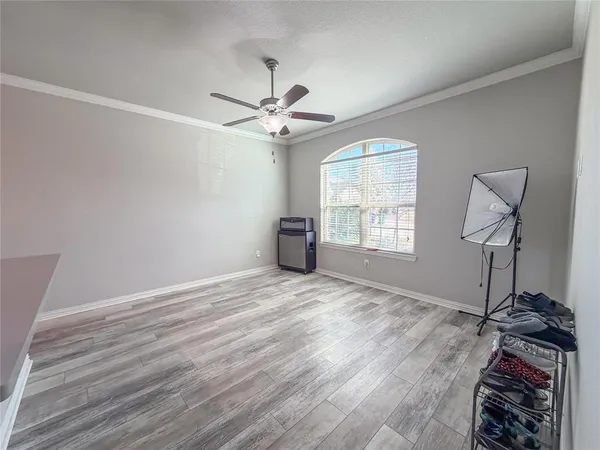 a bedroom with a bed and a ceiling fan in it