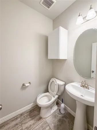 a bathroom with a sink a toilet and mirror