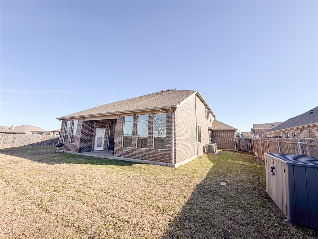 328 Callaghan Drive Fate, TX 75189 - Photo 34 of 37 a view of a house with a yard and wooden fence