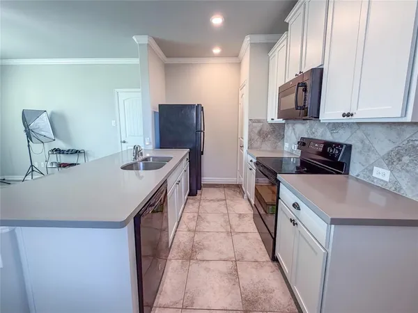 a kitchen with a sink and a refrigerator