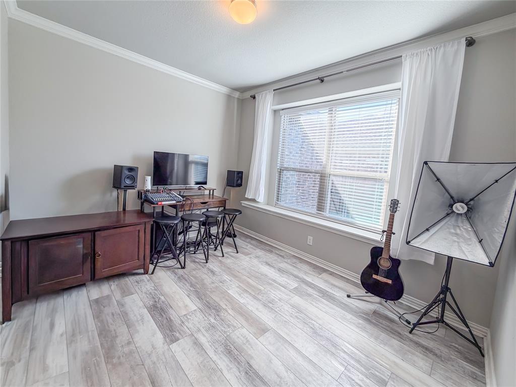 328 Callaghan Drive Fate, TX 75189 - Photo 9 of 37 a workspace with furniture window and wooden floor