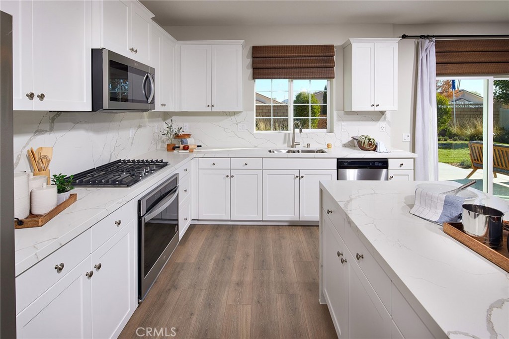 31099 Scrub Jay Road Winchester, CA 92596 - Photo 4 of 9 a kitchen with sink cabinets and window
