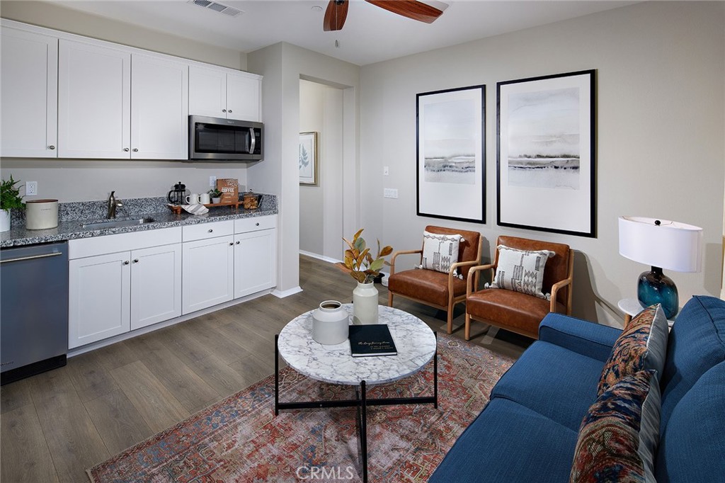 31099 Scrub Jay Road Winchester, CA 92596 - Photo 8 of 9 a living room with furniture a rug and a fireplace