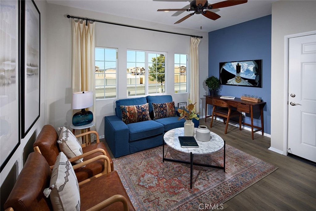 31099 Scrub Jay Road Winchester, CA 92596 - Photo 9 of 9 a living room with furniture a chandelier and a flat screen tv