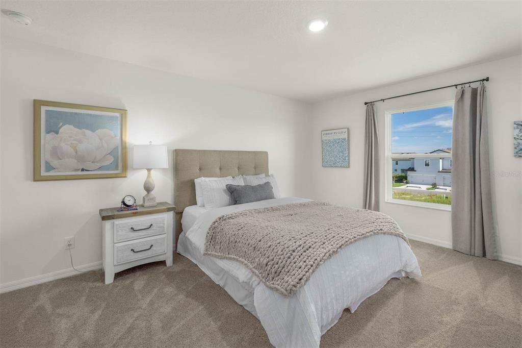 721 Poppy Lane Dundee, FL 33838 - Photo 17 of 26 a bedroom with a bed and a painting on the wall
