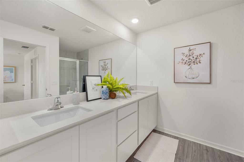721 Poppy Lane Dundee, FL 33838 - Photo 18 of 26 a bathroom with a sink a large mirror and a shower