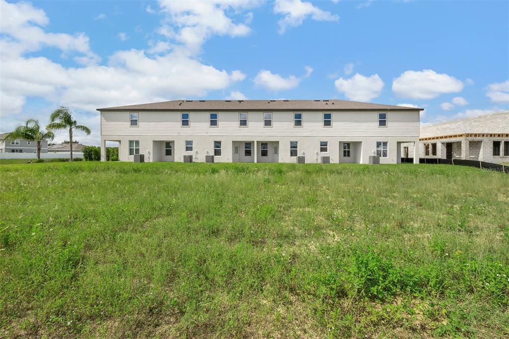 721 Poppy Lane Dundee, FL 33838 - Photo 25 of 26 a view of house with a big yard and potted plants