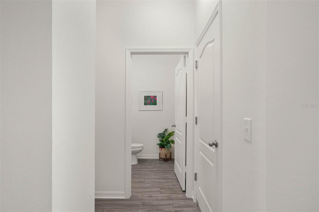 721 Poppy Lane Dundee, FL 33838 - Photo 5 of 26 a view of a hallway with wooden floor and a hallway