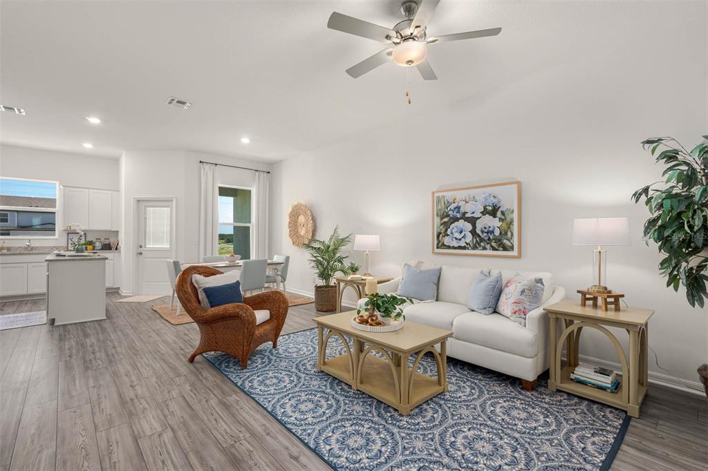 721 Poppy Lane Dundee, FL 33838 - Photo 6 of 26 a living room with furniture and a wooden floor