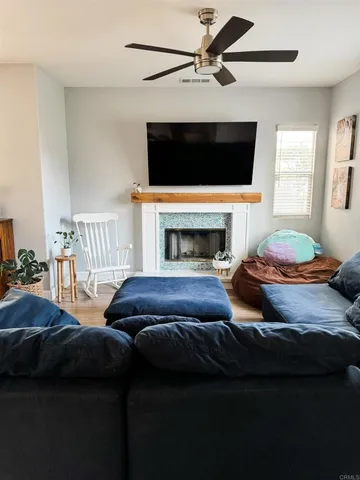 a living room with furniture and a fireplace
