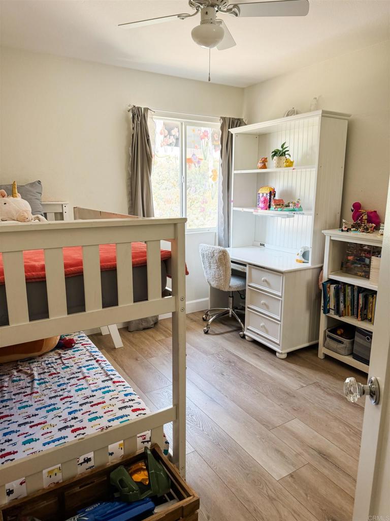 1461 Fieldbrook Street Chula Vista, CA 91913 - Photo 11 of 12 a bedroom with furniture window and wooden floor