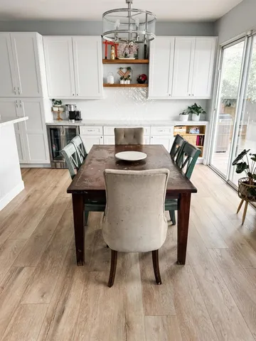 a kitchen with stainless steel appliances granite countertop a stove top oven a sink a counter space and dining table