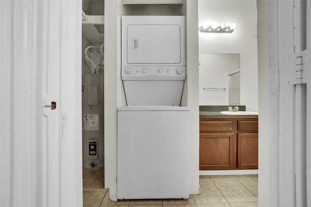 9254 Forest Lane, Unit 407 Dallas, TX 75243 - Photo 11 of 15 a room with a refrigerator and cabinets