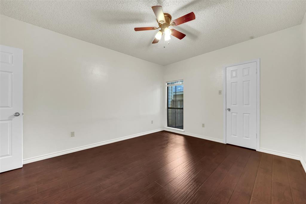 9254 Forest Lane, Unit 407 Dallas, TX 75243 - Photo 13 of 15 a view of an empty room with wooden floor