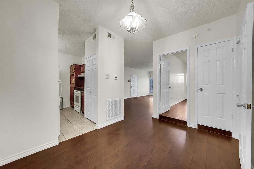 9254 Forest Lane, Unit 407 Dallas, TX 75243 - Photo 6 of 15 a view of a room with wooden floor and staircase