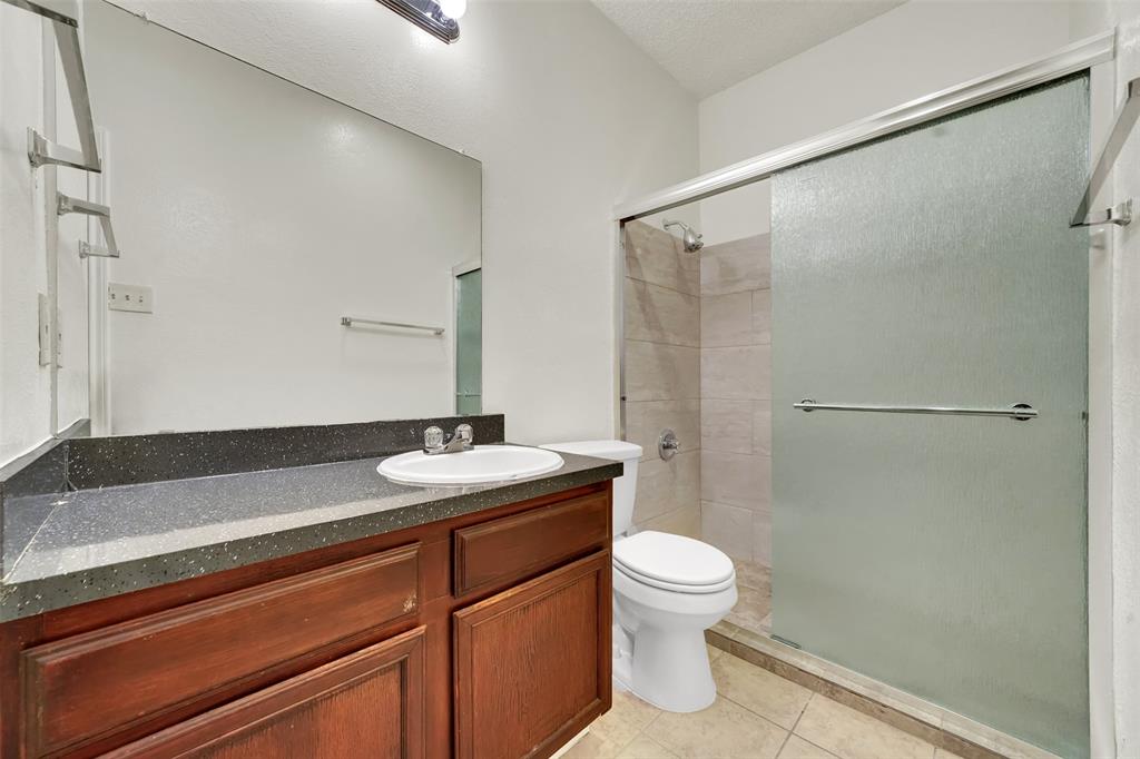 9254 Forest Lane, Unit 407 Dallas, TX 75243 - Photo 10 of 15 a bathroom with a sink a toilet and shower