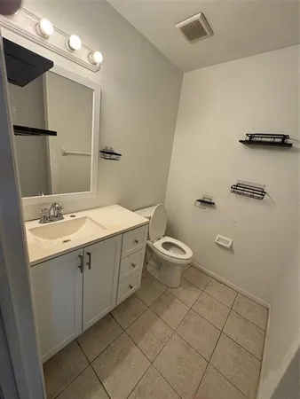 a bathroom with a double vanity sink mirror and toilet