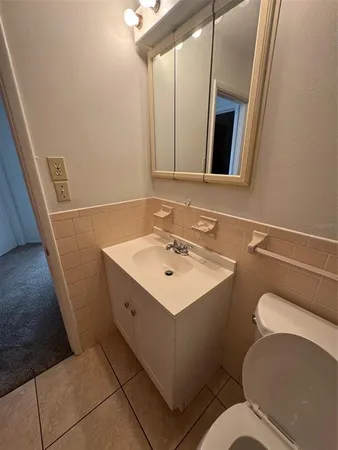 a bathroom with a sink toilet and mirror