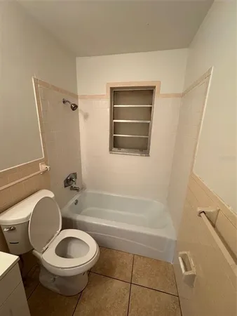 a bathroom with a toilet a sink and bathtub