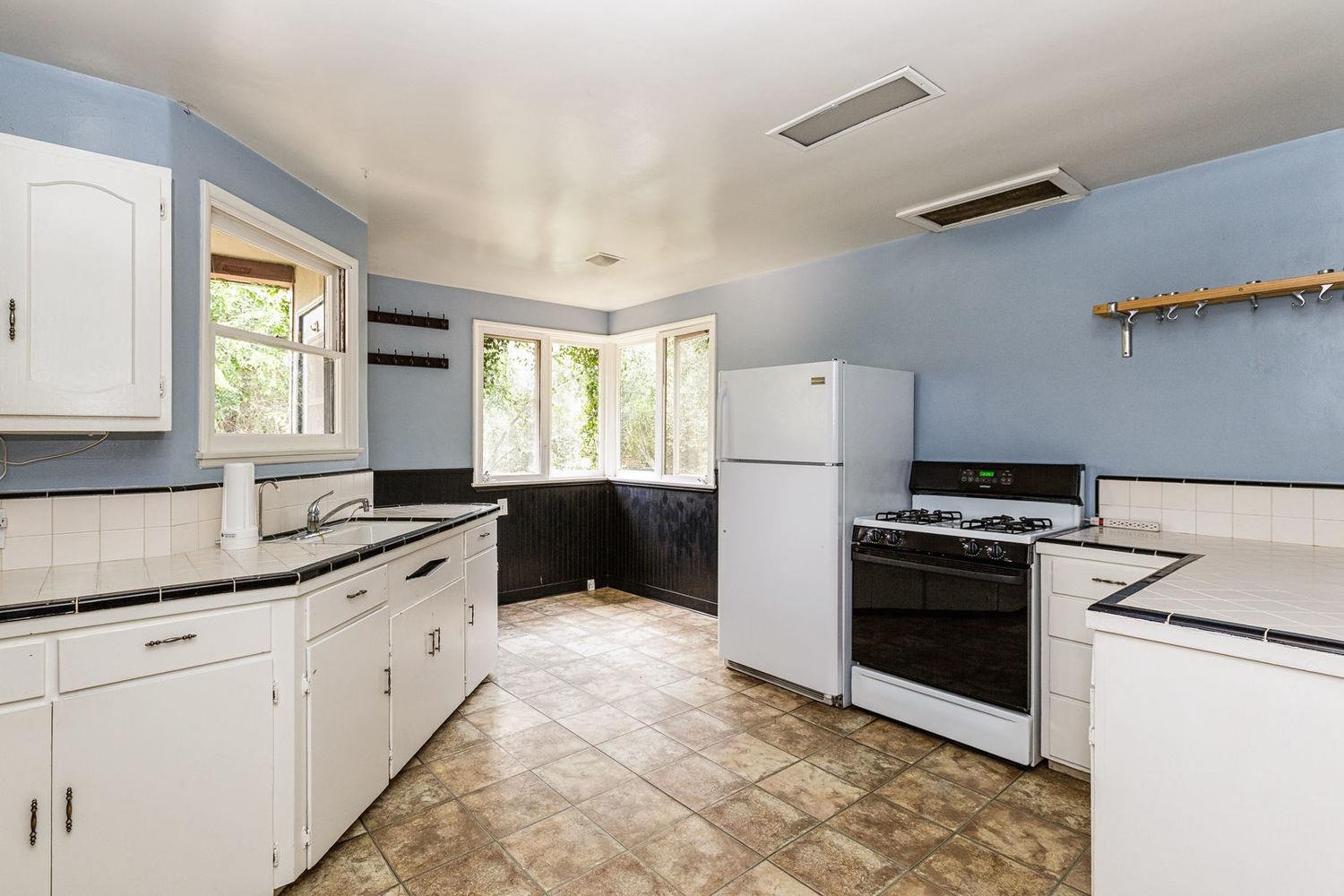 902 Daly Road Ojai, CA 93023 - Photo 6 of 13 a kitchen with granite countertop a refrigerator stove and sink