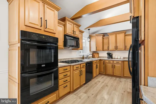 a kitchen with stainless steel appliances granite countertop a stove microwave and sink
