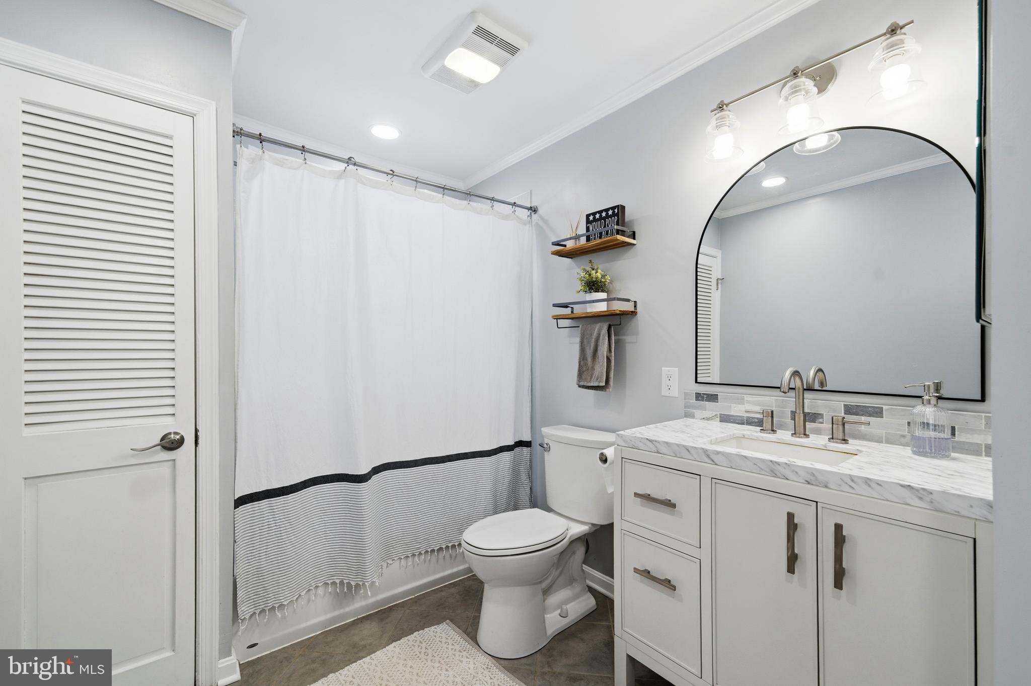 4030 Ravine Drive White Plains, MD 20695 - Photo 11 of 64 a bathroom with a toilet sink and mirror