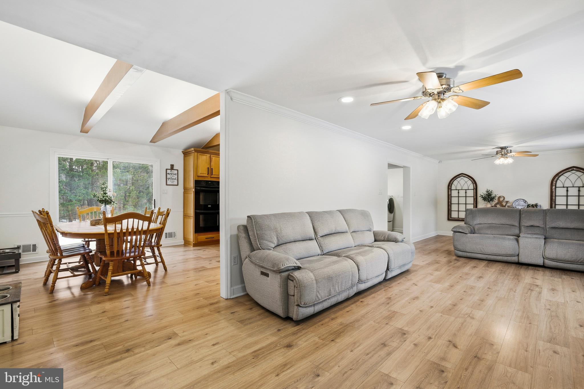 4030 Ravine Drive White Plains, MD 20695 - Photo 22 of 64 a living room with furniture a dining table and a fireplace