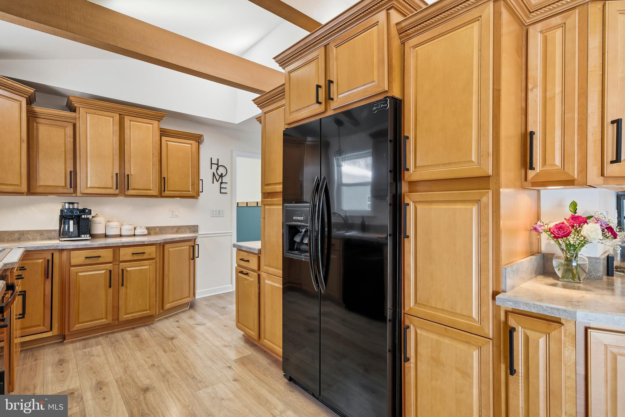 4030 Ravine Drive White Plains, MD 20695 - Photo 27 of 64 a kitchen with granite countertop stainless steel appliances a refrigerator and cabinets