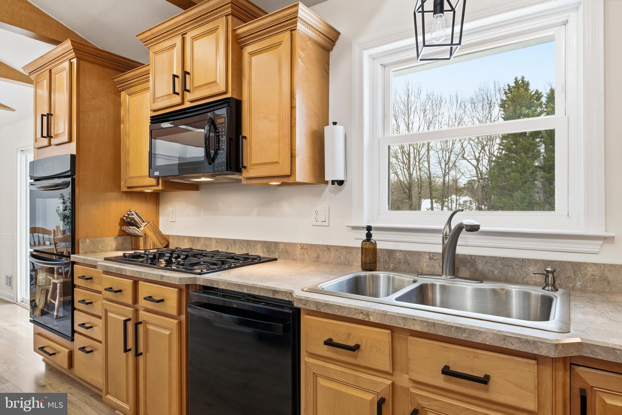 4030 Ravine Drive White Plains, MD 20695 - Photo 28 of 64 a kitchen with stainless steel appliances granite countertop a sink a stove and a microwave
