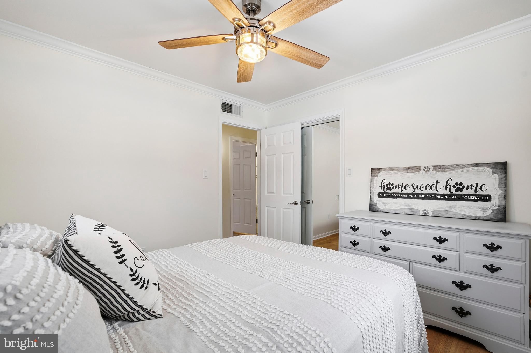 4030 Ravine Drive White Plains, MD 20695 - Photo 37 of 64 a bedroom with a bed and a chandelier