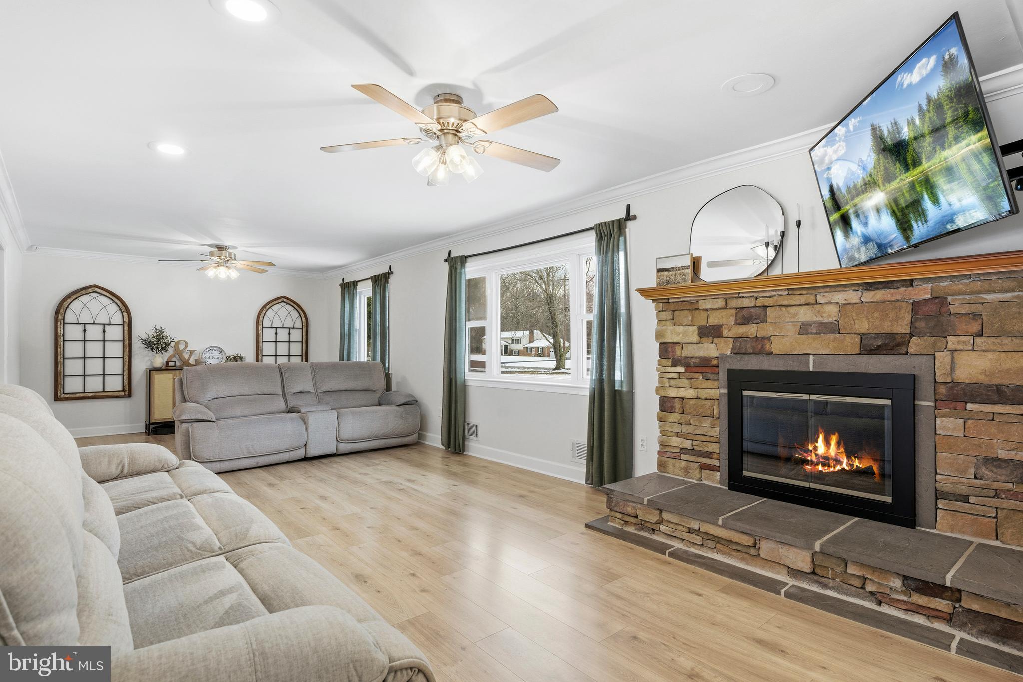 4030 Ravine Drive White Plains, MD 20695 - Photo 6 of 64 a living room with furniture a fireplace and a flat screen tv