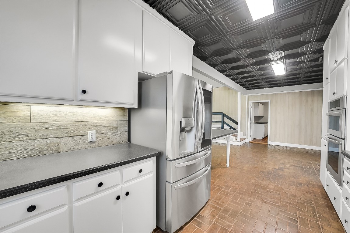 1005 Church Street Brenham, TX 77833 - Photo 15 of 44 a kitchen with stainless steel appliances granite countertop a refrigerator and a sink
