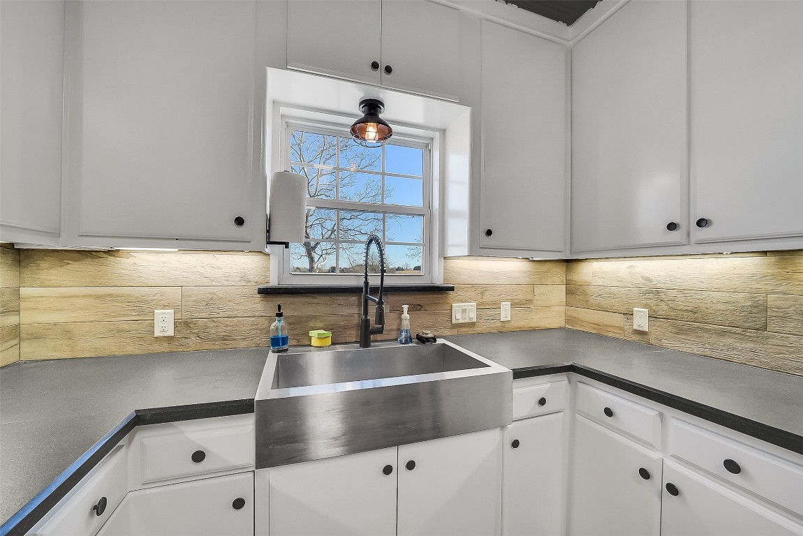 1005 Church Street Brenham, TX 77833 - Photo 17 of 44 a kitchen with stainless steel appliances cabinets and a window