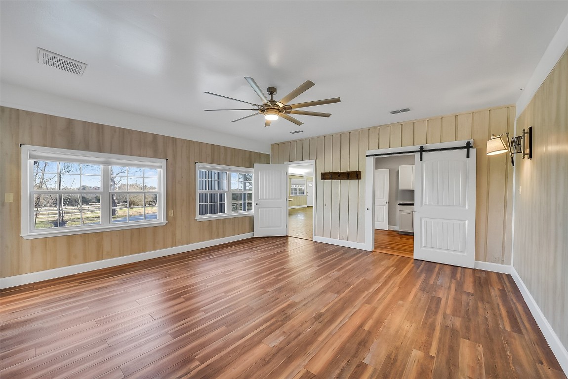 1005 Church Street Brenham, TX 77833 - Photo 20 of 44 a view of an empty room with a window and wooden floor