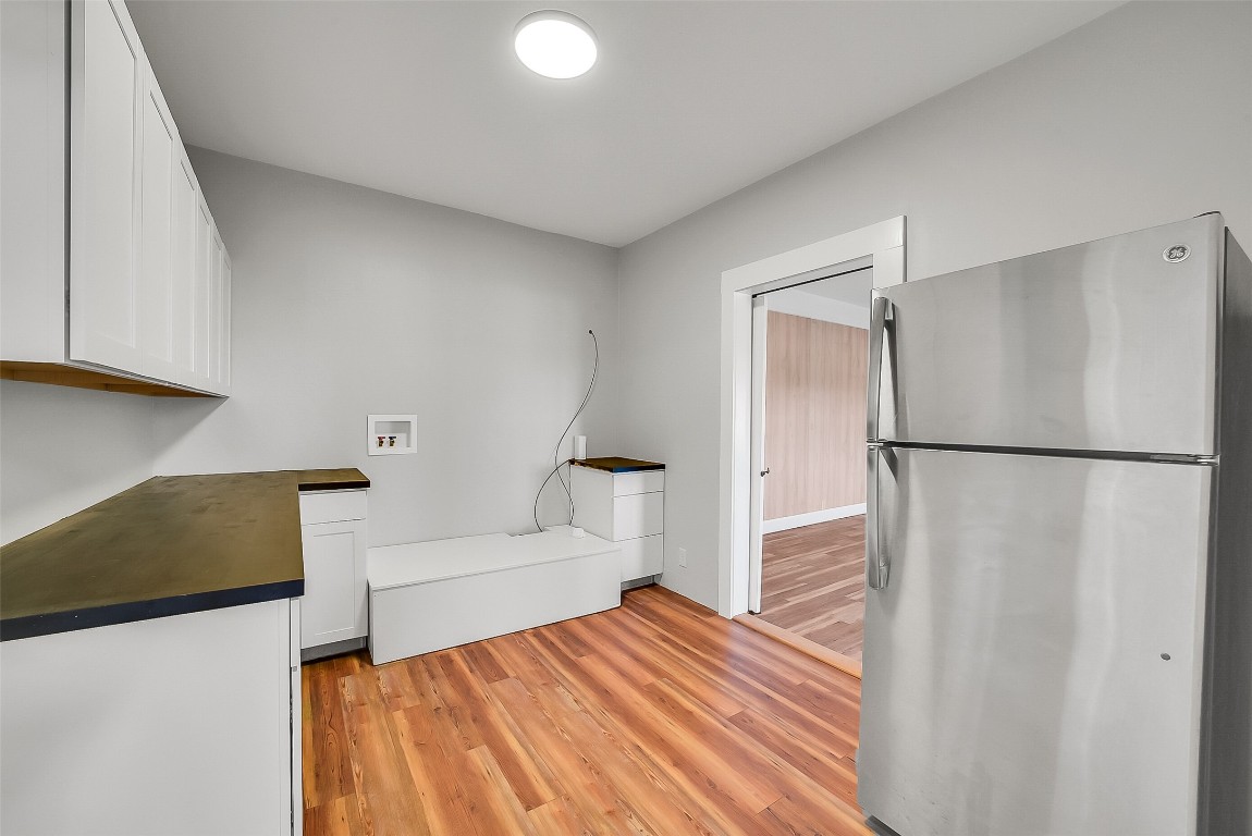 1005 Church Street Brenham, TX 77833 - Photo 26 of 44 a bedroom with a bed and a refrigerator