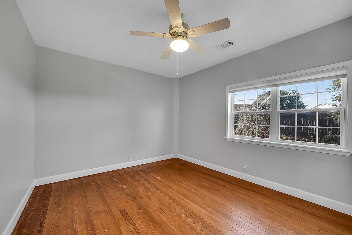 1005 Church Street Brenham, TX 77833 - Photo 29 of 44 wooden floor in an empty room with a window