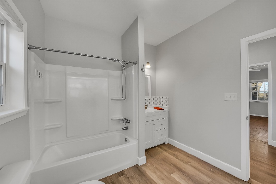 1005 Church Street Brenham, TX 77833 - Photo 31 of 44 a bathroom with a bathtub and shower
