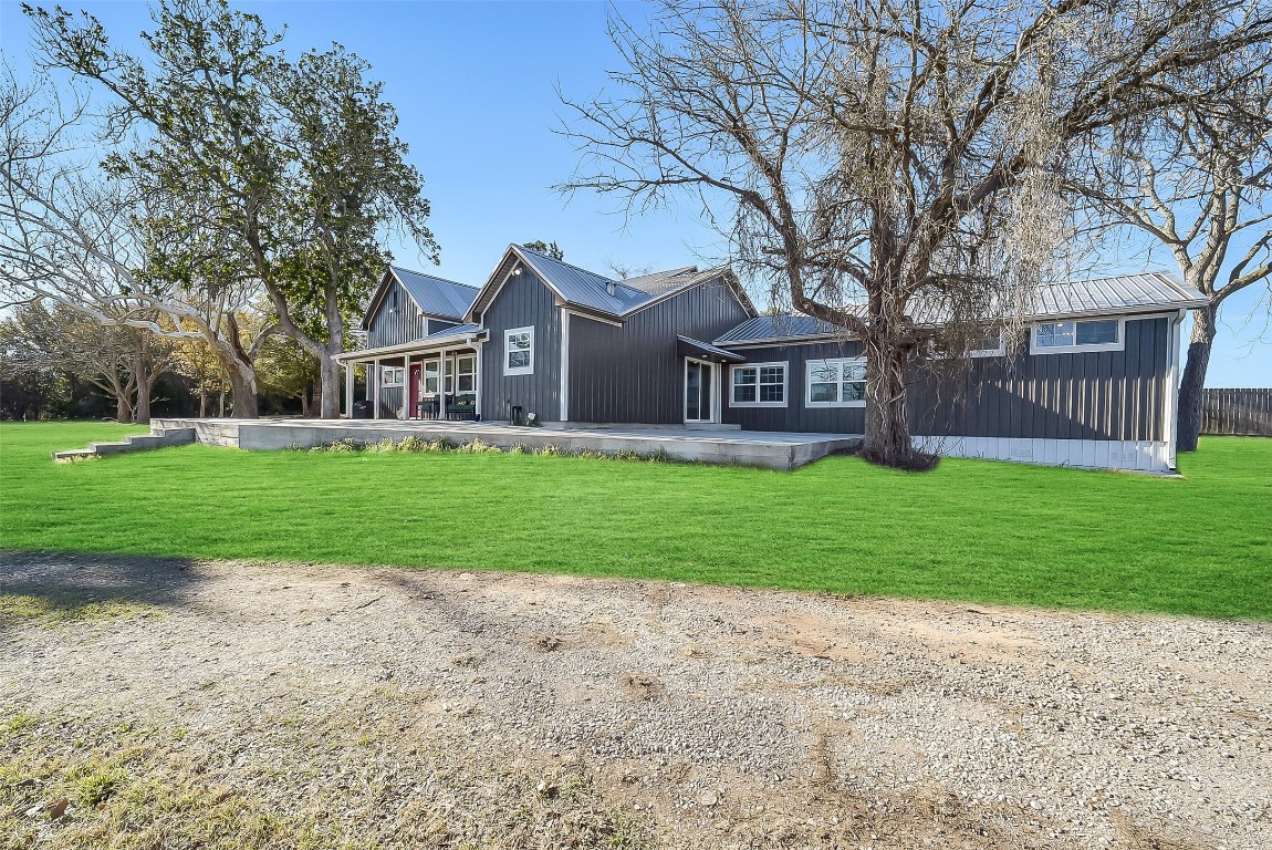 1005 Church Street Brenham, TX 77833 - Photo 5 of 44 a front view of a house with a garden and trees