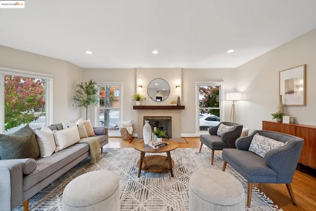 a view of a hallway with wooden floor and a living room