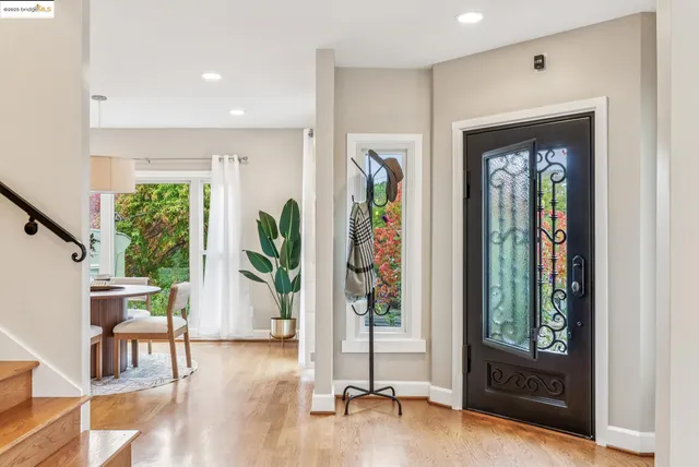 a living room with furniture a fireplace and a potted plant