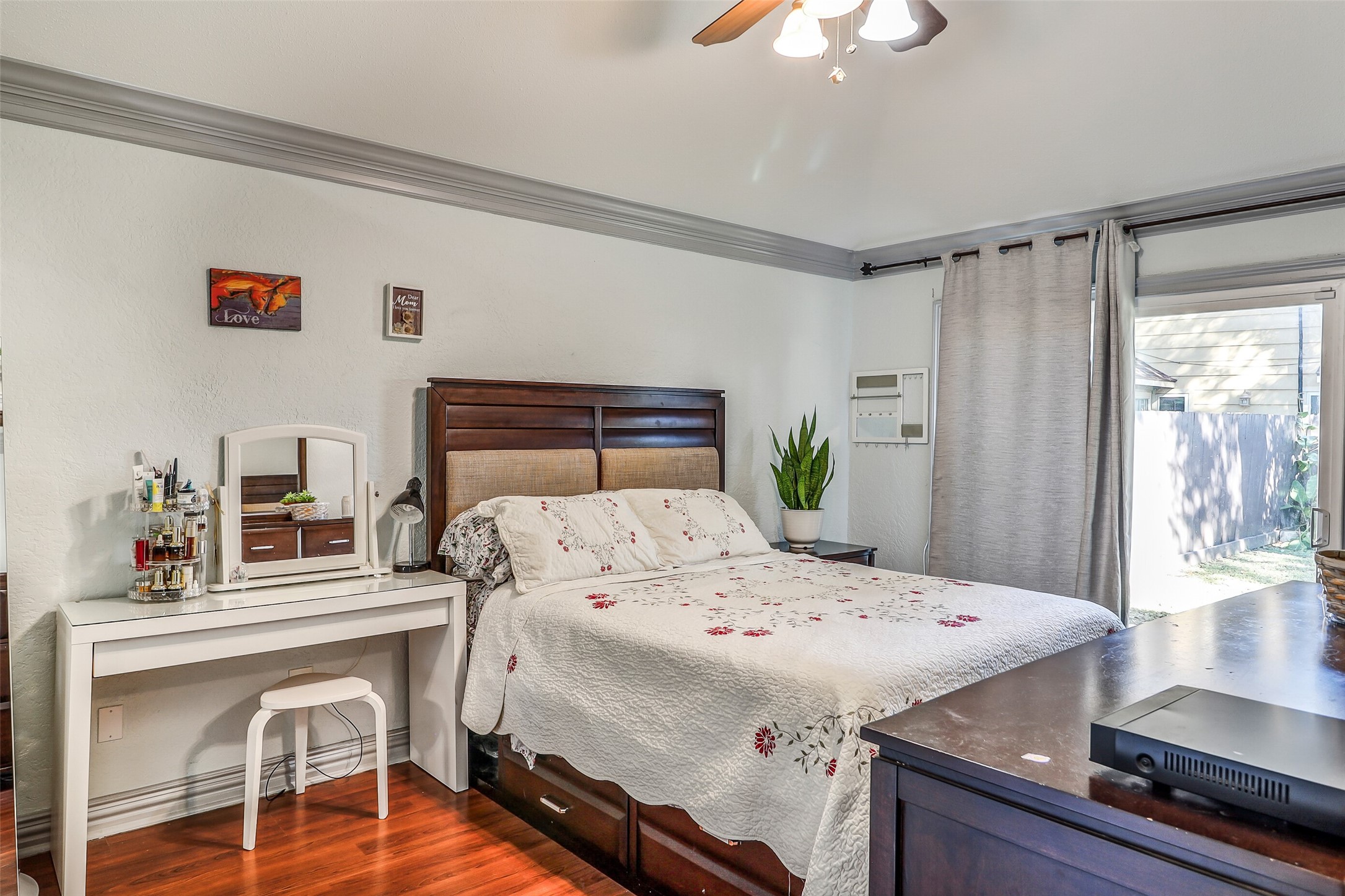 15922 Riverside Grove Drive Houston, TX 77083 - Photo 11 of 23 a bedroom with a bed and a chandelier