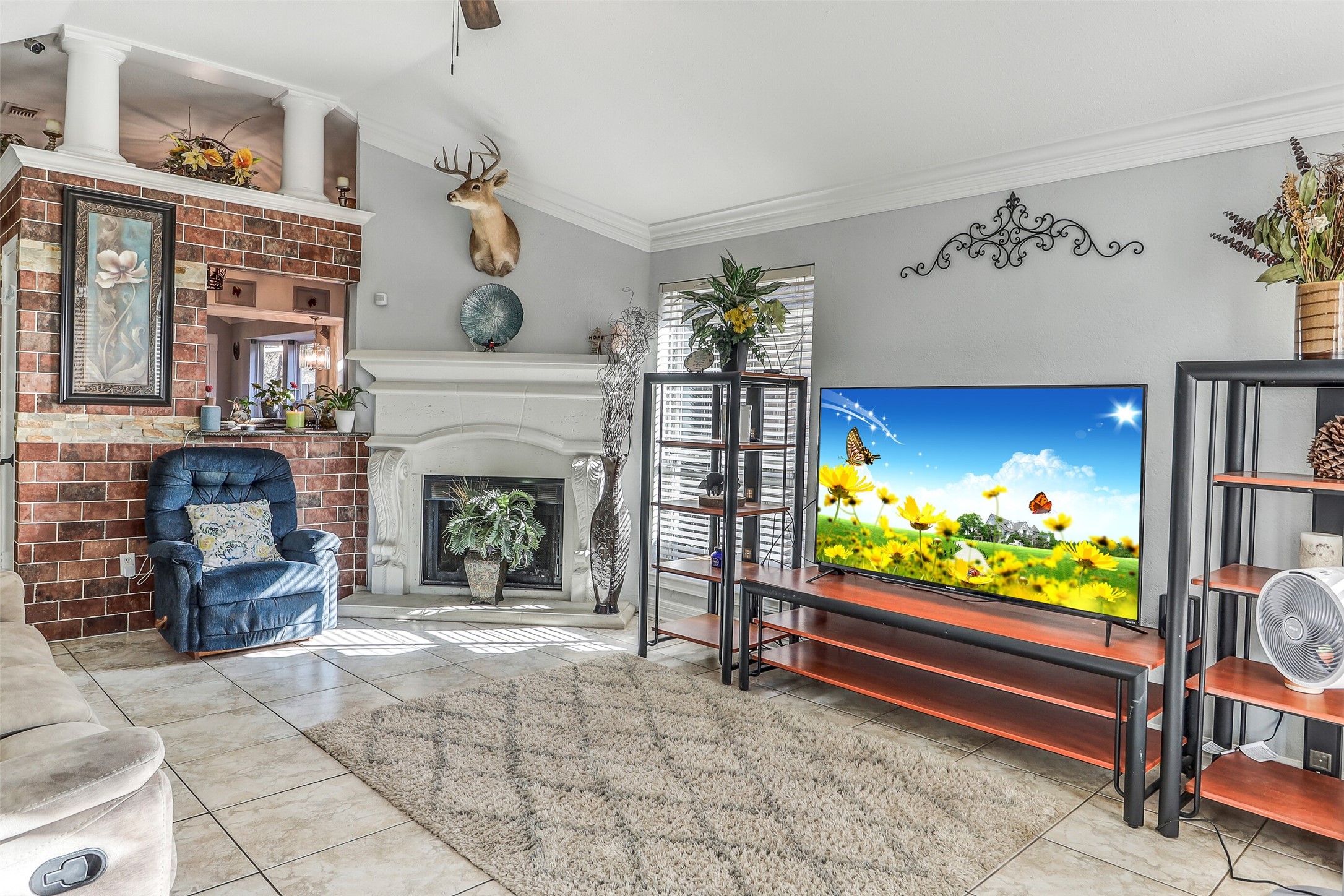 15922 Riverside Grove Drive Houston, TX 77083 - Photo 4 of 23 a living room with furniture a flat screen tv and a fireplace