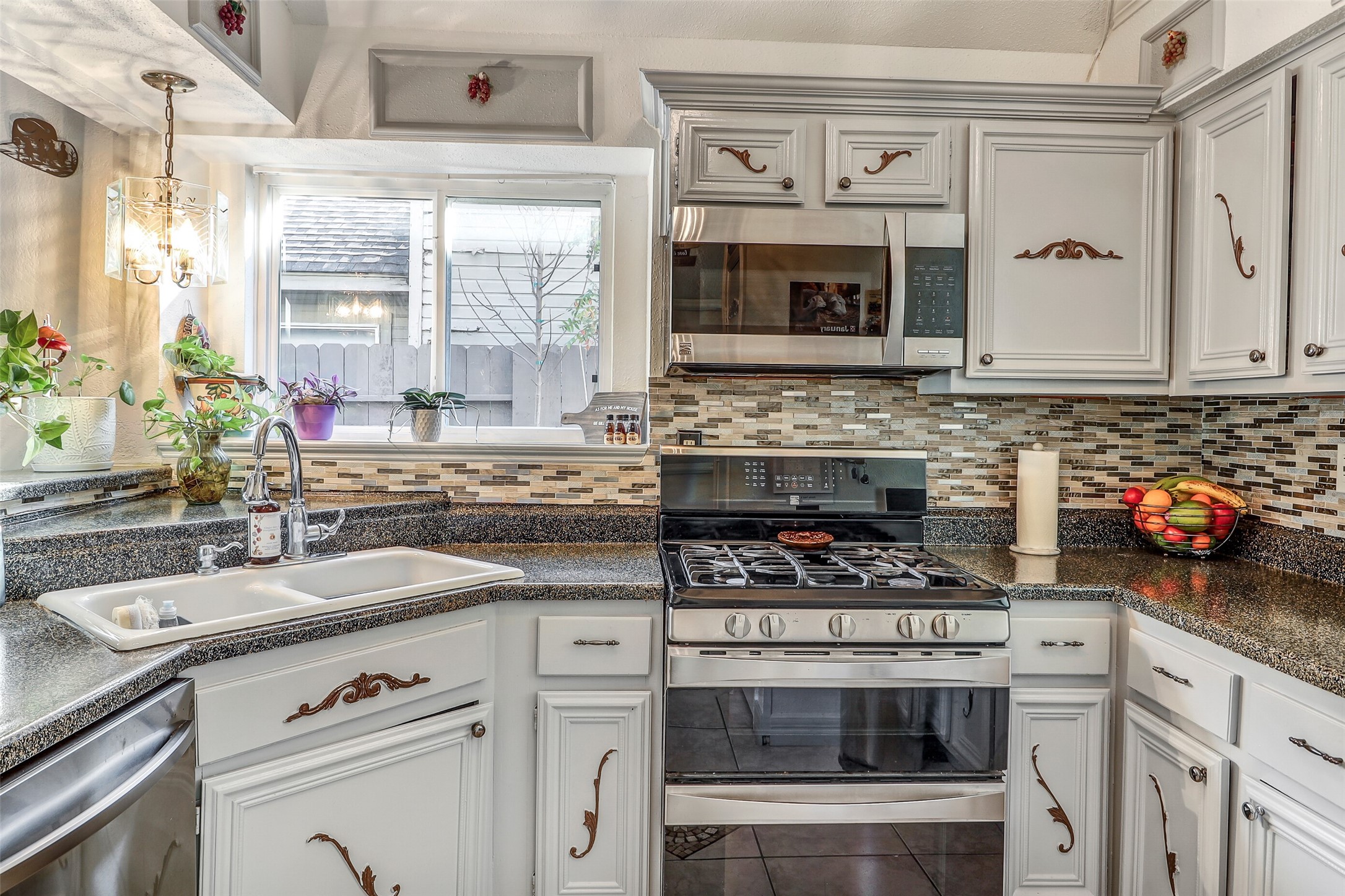15922 Riverside Grove Drive Houston, TX 77083 - Photo 6 of 23 a kitchen with a stove and a sink