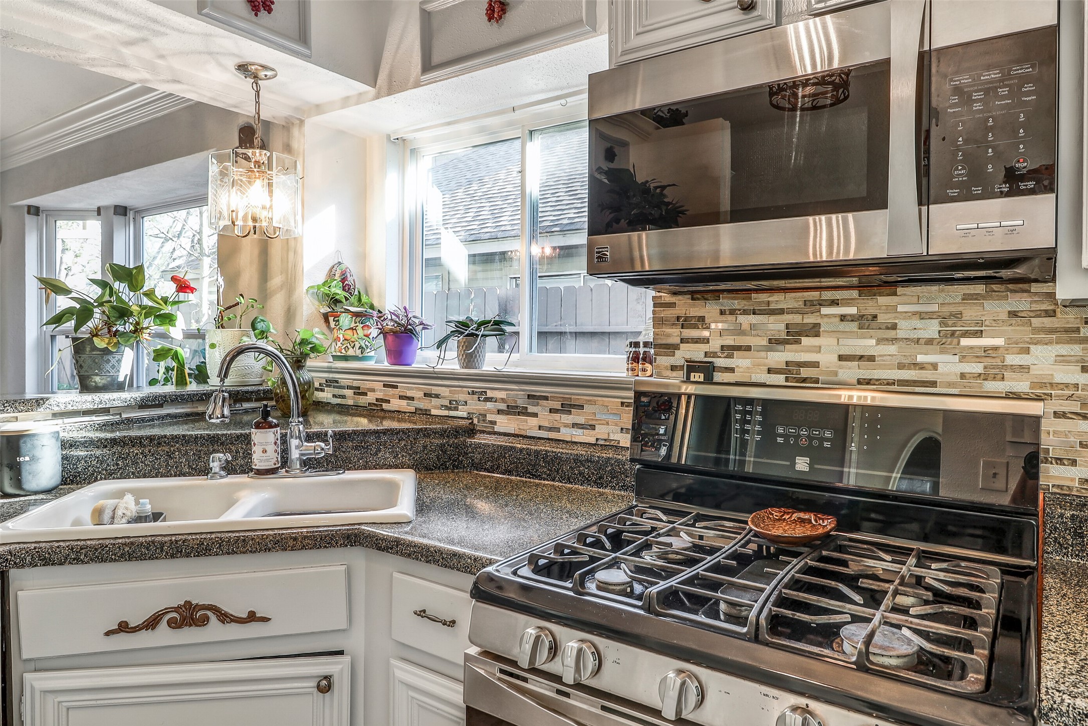 15922 Riverside Grove Drive Houston, TX 77083 - Photo 7 of 23 a kitchen with a stove and a sink