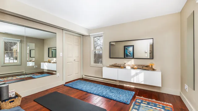 a spacious bedroom with a bed and a dresser in it