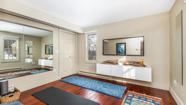 a spacious bedroom with a bed and a dresser in it
