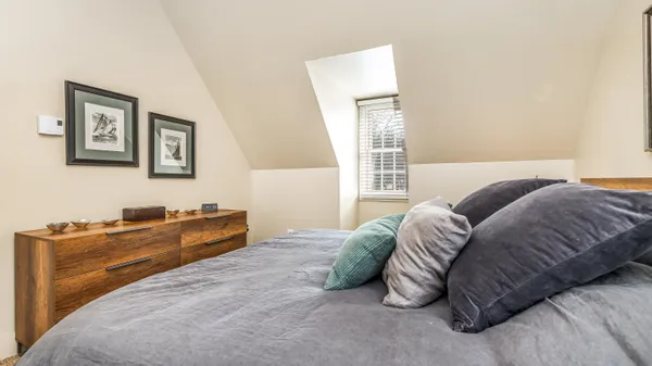 a room with a baby bed furniture and a window