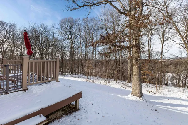a view of a house with backyard and wooden fence